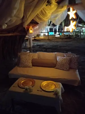 a couch sitting under a tent with a table at Hotel Portobello in Coveñas