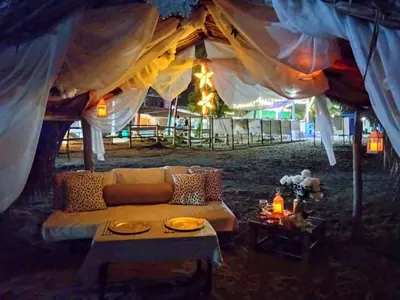 a living room with a couch in a tent at Hotel Portobello in Coveñas