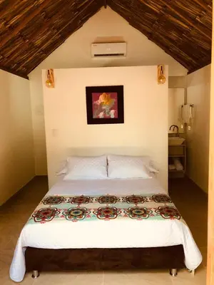 a bedroom with a large bed in a room at Anuk Glamping in San Bernardo del Viento