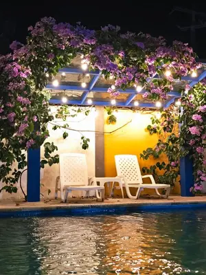 a group of chairs sitting next to a swimming pool at Anuk Glamping in San Bernardo del Viento