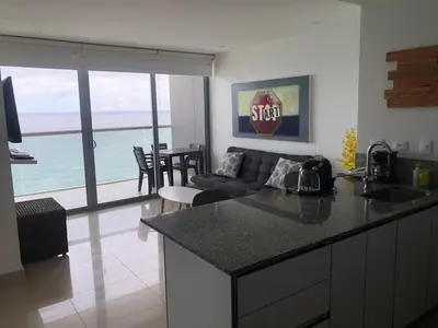 a kitchen and living room with a view of the ocean at Apartamentos frente al mar en Morros City in Cartagena de Indias