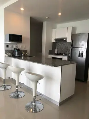 a kitchen with a counter and bar stools in it at Apartamentos frente al mar en Morros City in Cartagena de Indias