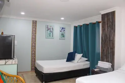 a hotel room with a bed and a tv at Hotel Marie Real Cartagena in Cartagena de Indias