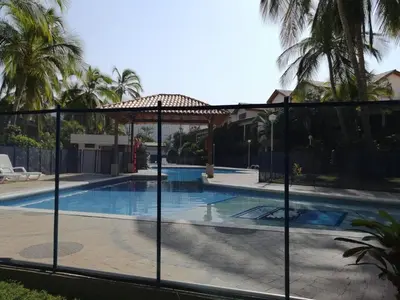 a fence around a swimming pool with a swimming pool at Casa, playa Bello Horizonte Santa Marta Colombia in Santa Marta