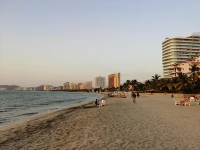 a beach with people and buildings and the ocean at Casa, playa Bello Horizonte Santa Marta Colombia in Santa Marta