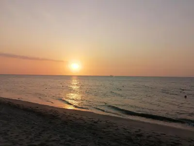 a sunset on a beach with the ocean at Casa, playa Bello Horizonte Santa Marta Colombia in Santa Marta