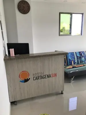 a wooden counter with a sign on it in a room at Hostal Cartagena Sun in Cartagena de Indias