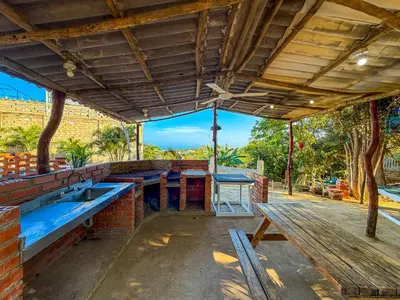 an outdoor bar with blue tables and a wooden roof at PALOMAR EcoCabaña in Santa Veronica