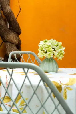a white vase with flowers on a table at Casa Renacer in Cartagena de Indias