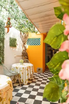 a room with a table and a tree on a checkered floor at Casa Renacer in Cartagena de Indias