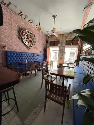a restaurant with tables and chairs and a brick wall at Hotel Mangata in Cartagena de Indias