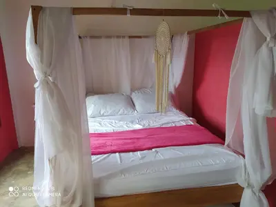 a bed with a canopy in a room at Los Versos de Zaira in San Onofre