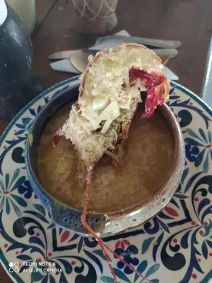 a piece of cake is in a bowl of soup at Los Versos de Zaira in San Onofre
