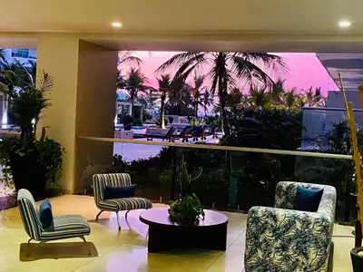 a lobby with chairs and a table and a patio at MORROS EPIC luxury beach in Cartagena de Indias