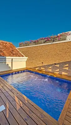 a swimming pool on the deck of a house at Lunalá Hotel Boutique in Cartagena de Indias