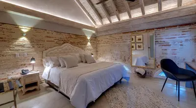 a bedroom with a bed and a desk and a chair at Lunalá Hotel Boutique in Cartagena de Indias