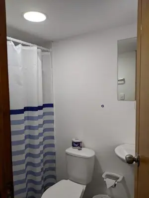 a bathroom with a white toilet and a sink at Hotel ITACO in Cartagena de Indias