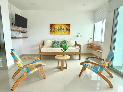 a living room with two chairs and a couch at Magico Apartamento Frente al Mar 3 Habitaciones B21 in Coveñas