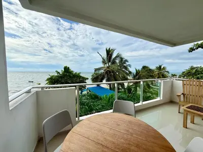 a balcony with a table and a view of the ocean at Magico Apartamento Frente al Mar 3 Habitaciones B21 in Coveñas