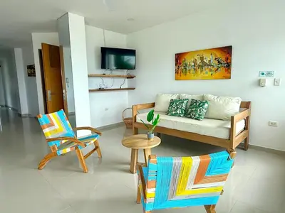 a living room with a couch and two chairs at Magico Apartamento Frente al Mar 3 Habitaciones B21 in Coveñas