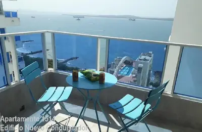 a table and chairs on the balcony of a building at Shark 1514 Nuevo Conquistador in Cartagena de Indias