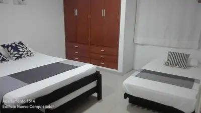 a bedroom with two twin beds and a dresser at Shark 1514 Nuevo Conquistador in Cartagena de Indias