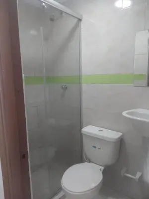 a bathroom with a toilet and a shower and a sink at HOTEL BOSQUE DE LAS AMERICAS in Cartagena de Indias