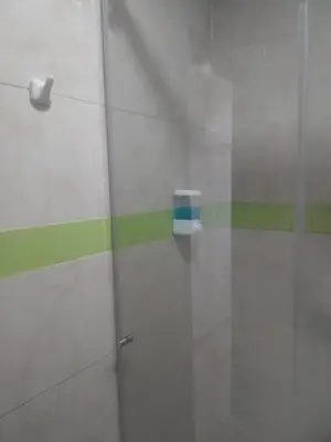 a glass door with a soap dispenser on a wall at HOTEL BOSQUE DE LAS AMERICAS in Cartagena de Indias
