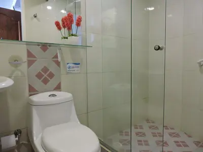 a bathroom with a toilet and a glass shower at Estudio Loft Cartagena in Cartagena de Indias