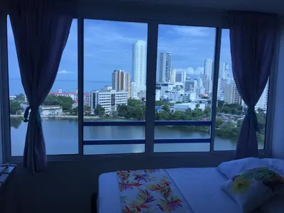 a bedroom with a window with a view of a city at Estudio Loft Cartagena in Cartagena de Indias