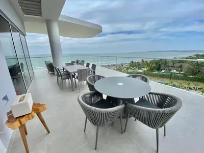 a balcony with tables and chairs and a view of the ocean at Serena del Mar, Morros IO in Cartagena de Indias