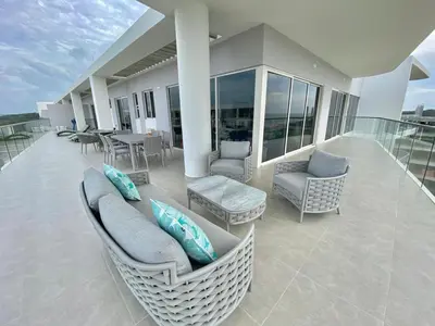a balcony with a couch and chairs on a house at Serena del Mar, Morros IO in Cartagena de Indias