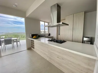 a kitchen with a counter with a view of a table at Serena del Mar, Morros IO in Cartagena de Indias