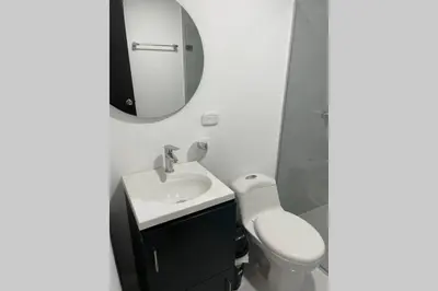 a bathroom with a sink and a toilet and a mirror at Apto en Getsemani el barrio mas cool de Cartagena in Cartagena de Indias