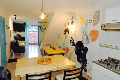 a kitchen and living room with a table and a dining room at Apto en Getsemani el barrio mas cool de Cartagena in Cartagena de Indias