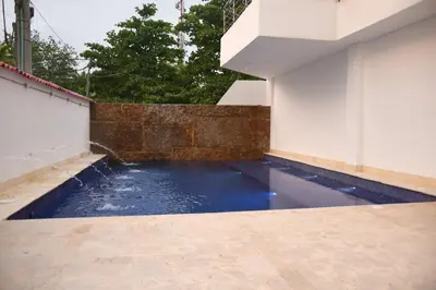a pool of water on the side of a building at Playa Norte Hotel in Cartagena de Indias