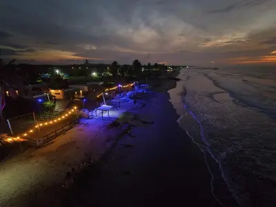an overhead view of a beach at night with lights at AGUAMARINA House in San Bernardo del Viento