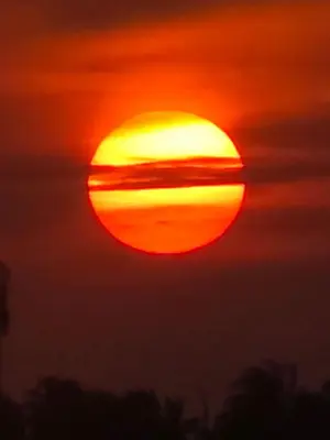 a sunset with the sun in the sky at AGUAMARINA House in San Bernardo del Viento