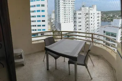 a table and chairs on the balcony of a building at Oferta frente a la playa Cartagena . En, Sp, It. in Cartagena de Indias