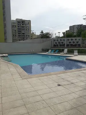 a large swimming pool in the middle of a building at Rincon 94- Barranquilla- Rio Alto in Barranquilla