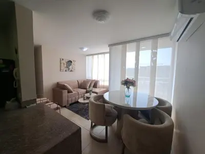 a living room with a table and chairs and a couch at Torino Barranquilla- Miramar in Barranquilla