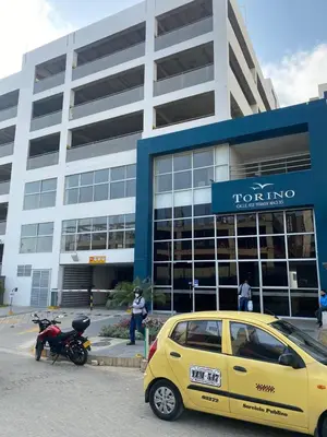 a yellow car parked in front of a building at Torino Barranquilla- Miramar in Barranquilla