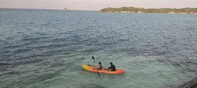 two people are sitting on a kayak in the water at Rosario EcoHotel - Islas del Rosario in Isla Grande