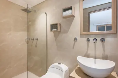 a bathroom with a sink and a glass shower at Apartamentos casa Gimani in Cartagena de Indias