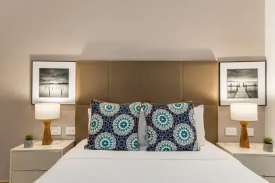 a bedroom with a large bed with two lamps at Apartamentos casa Gimani in Cartagena de Indias