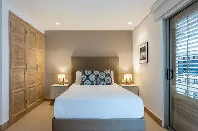 a bedroom with a large bed and two night stands at Apartamentos casa Gimani in Cartagena de Indias