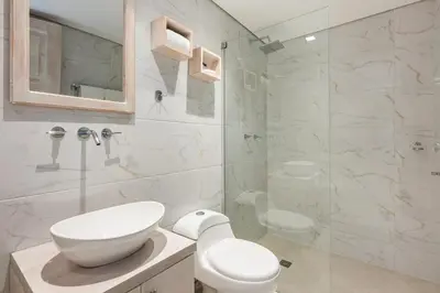 a bathroom with a toilet and a sink and a shower at Apartamentos casa Gimani in Cartagena de Indias