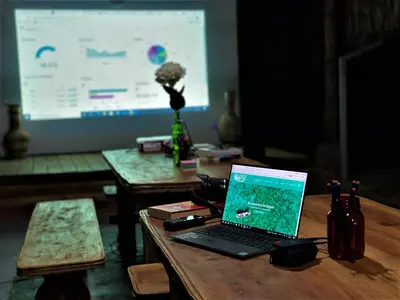a laptop computer sitting on a table in front of a screen at Isla Fuerte - Wiji Island House in Isla Fuerte