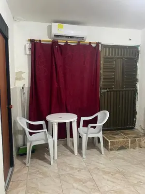 a table and two chairs in a room with a red curtain at Sophia House in Cartagena de Indias