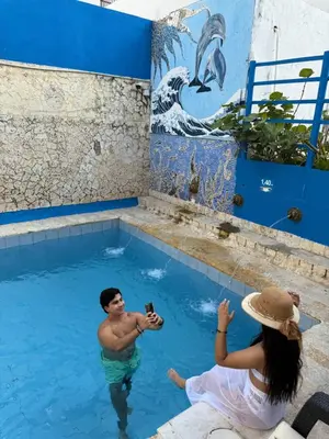 a man and a woman in a swimming pool at Hotel Toledo FL in Cartagena de Indias